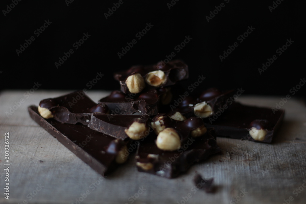 broken pieces of black chocolate with nuts