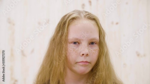 Portrait displeased girl looking with disgust to camera. Close up face disgusting girl teenager isolated in light studio. Disgusting, abominable, contempt and other negative people emotions