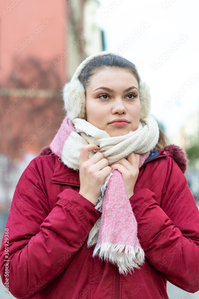 Beautiful young woman with eat muffs and scarf in Winter Beautiful young woman with eat muffs and scarf in Winter