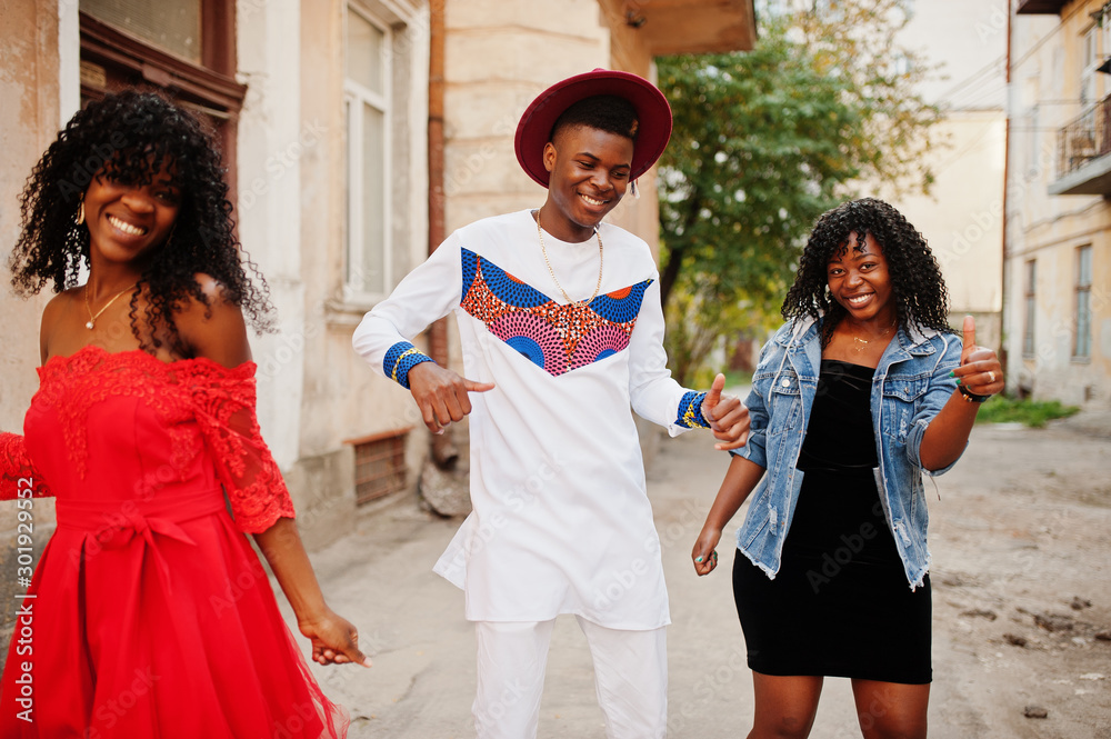 Group of three stylish trendy afro france friends posed at autumn day. Black african man model with two dark skinned womans. Group of three stylish trendy afro france friends posed at autumn day. Black african man model with two dark skinned womans.