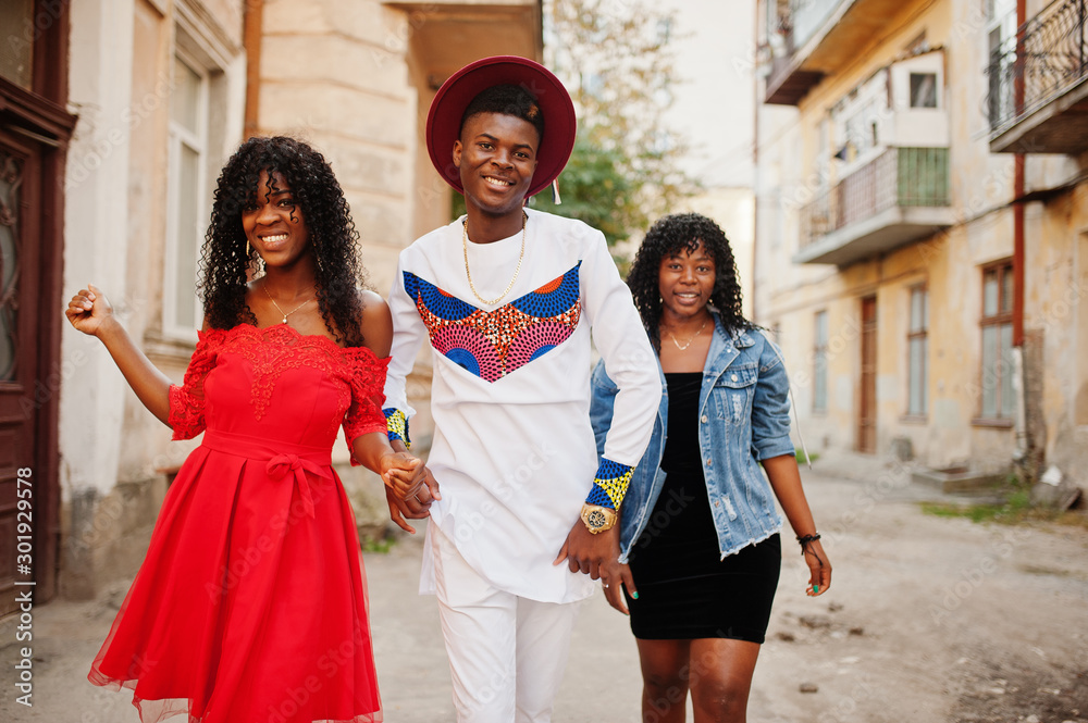 Group of three stylish trendy afro france friends posed at autumn day. Black african man model with two dark skinned womans.