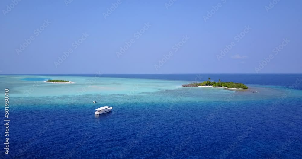 Touring boat just arrived close to tropical islands in the middle of turquoise lagoon surrounded by deep blue Indian ocean Touring boat just arrived close to tropical islands in the middle of turquoise lagoon surrounded by deep blue Indian ocean