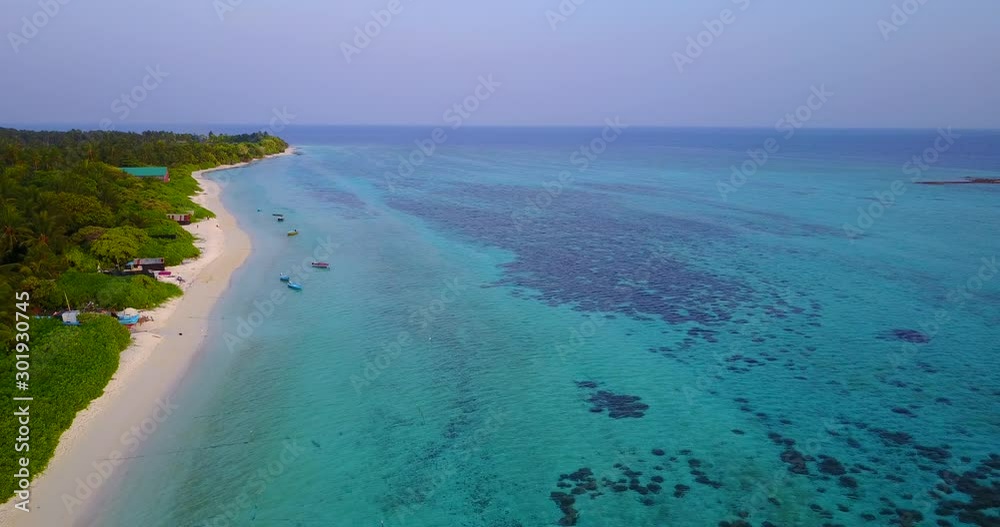 Wide turquoise lagoon with algae and corals under shallow water washing long white beach of tropical island in Philippines Wide turquoise lagoon with algae and corals under shallow water washing long white beach of tropical island in Philippines