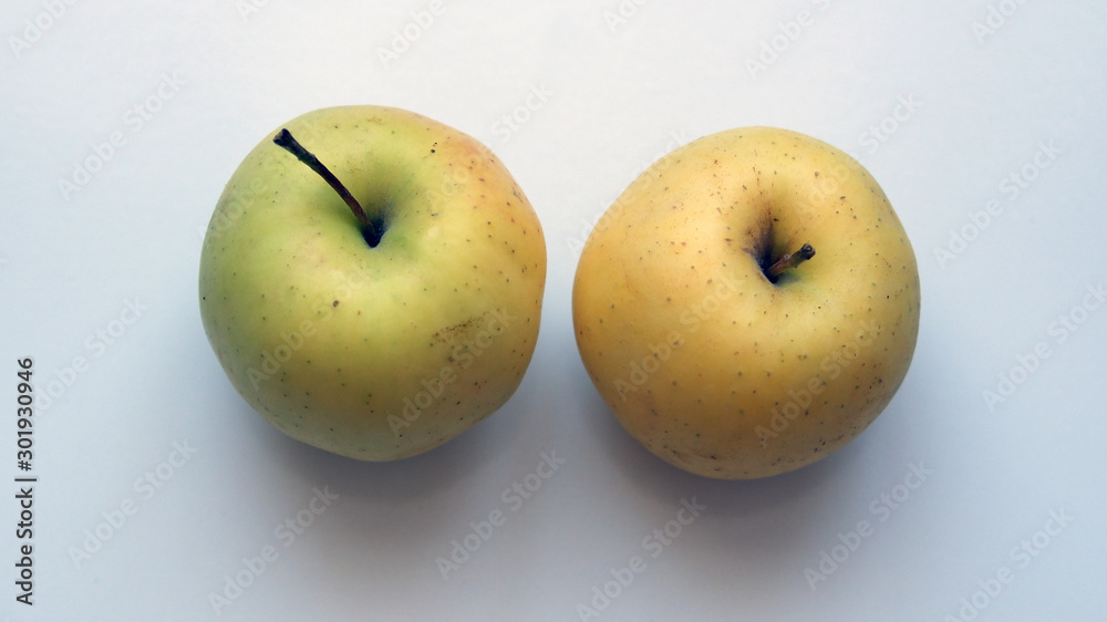 Organic yellow apple on a white background