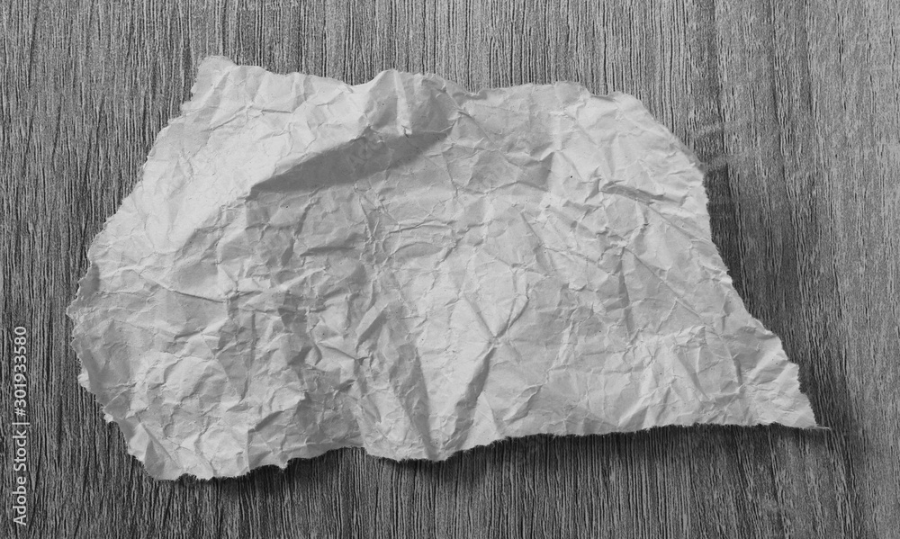 Obraz premium torn paper texture on wood background, copy space.