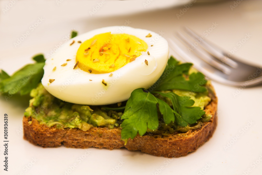 Guacamole toast and hard boiled egg with parsley, healthy diet concept Guacamole toast and hard boiled egg with parsley, healthy diet concept