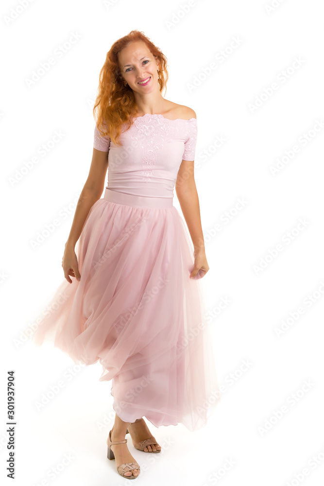 A beautiful young woman stands in the wind, the wind moves her c A beautiful young woman stands in the wind, the wind moves her c