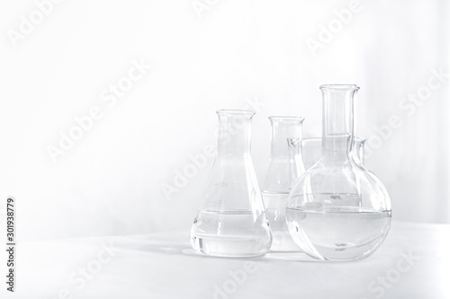 Science laboratory chemical beaker, Erlenmeyer and round flask lab glassware equipment. Research and development concept.