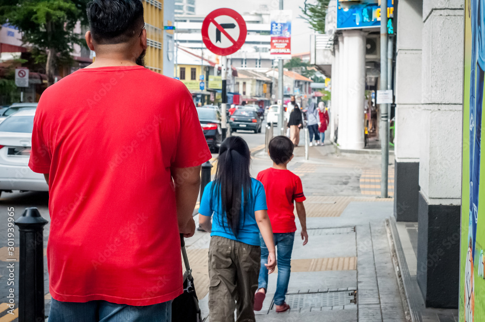Georgetown Penang - April 26 2019 :  People walking in the city exploring the beauty of old buildings.