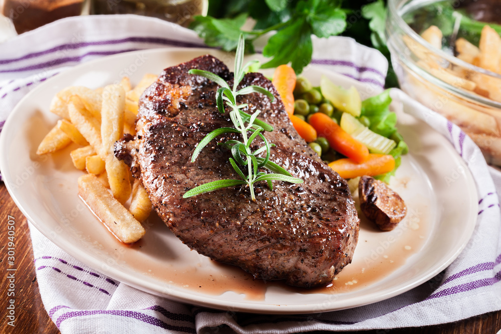 Beef steak served with baked potatoes