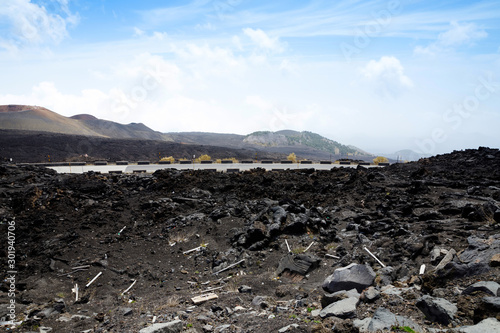 Panoramic wide view of the active volcano Etna on island Sicily, Italy extinct craters on the slope, traces of volcanic activity. Barren landscape of lava stones