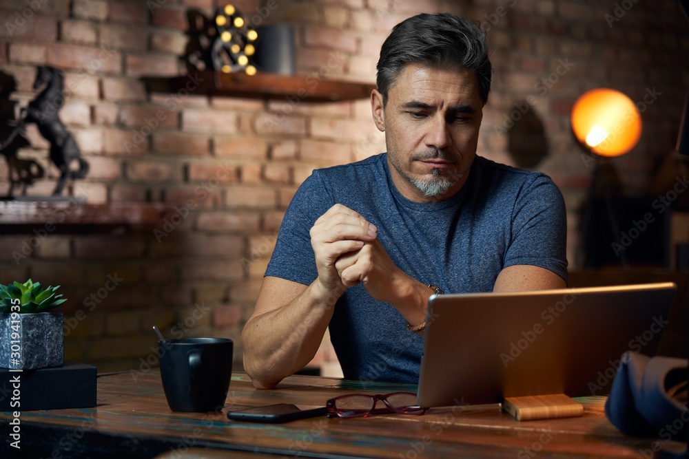 Older man working at desk using tablet Older man working at desk using tablet