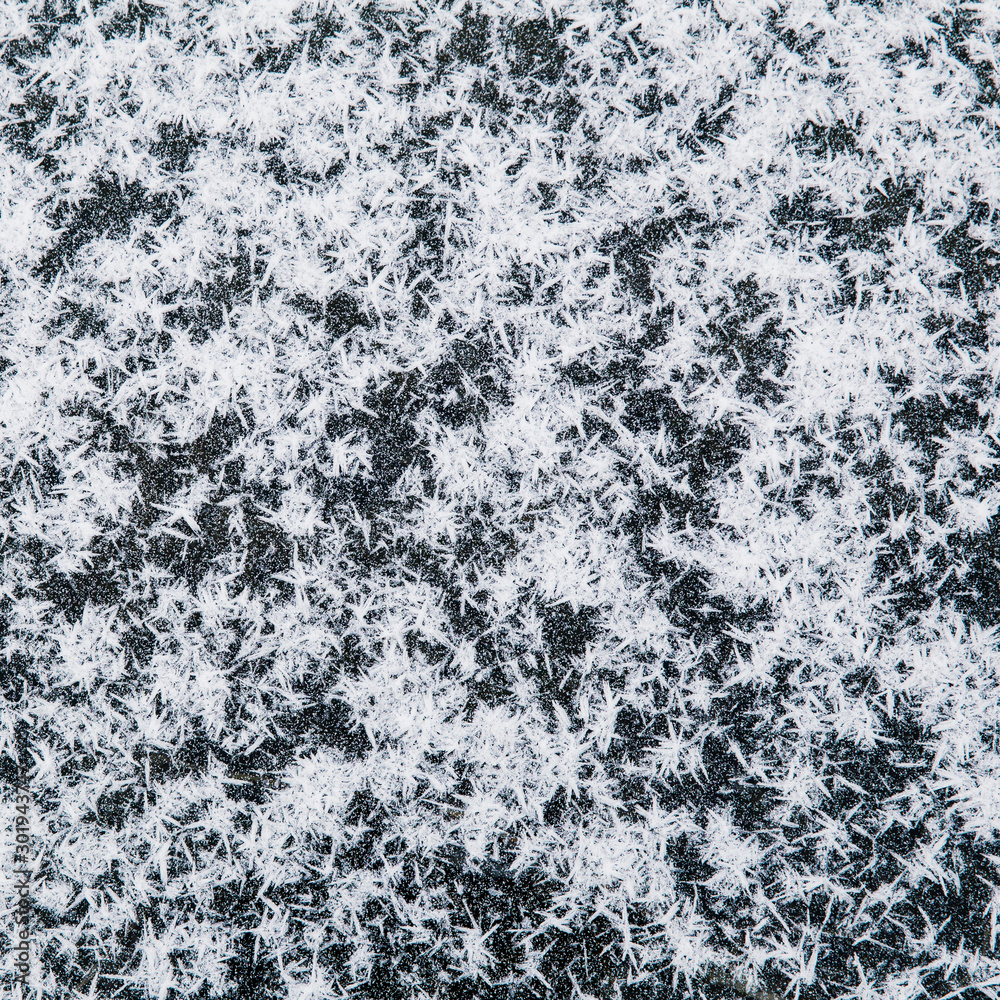 Natural snowflakes pattern, isolated on dark background. Top down view.