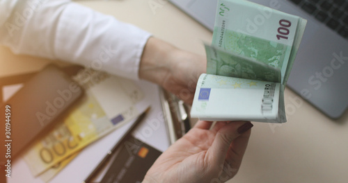 Close up of female hands counting euro banknotes. Business Woman Counting Money. © VAKSMANV
