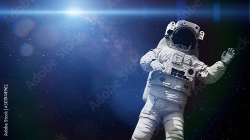 Fototapeta Naklejka Na Ścianę i Meble -  spacewalking astronaut lit by the Sun