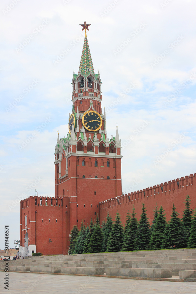 Moscow Kremlin Spasskaya Tower in the capital of Russia. Summer day view of Kremlin on the Red Square Moscow Kremlin Spasskaya Tower in the capital of Russia. Summer day view of Kremlin on the Red Square