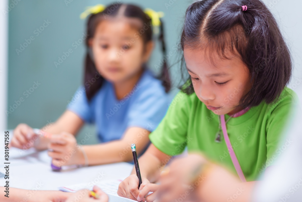 Asian elementary school girls are studying in the classroom. Asian elementary school girls are studying in the classroom.