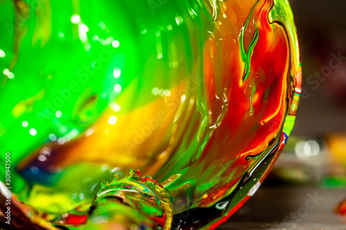 Close up of liquid artist colours on brush and pot photo