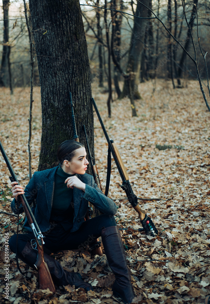 Naklejka premium hunting nature environment. military fashion. achievements of goals. successful hunt. hunting sport. woman with weapon. Target shot. girl with rifle. chase hunting. Gun shop. female hunter in forest