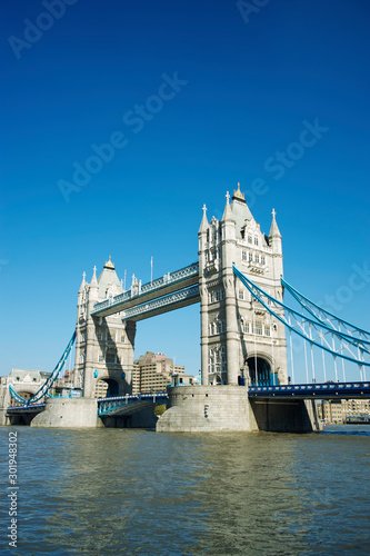 Bright sunny daytime view of Tower Bridge with clear blue sky above the River Thames in London, UK