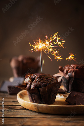 Sweet muffins with choccolate and sparkler photo