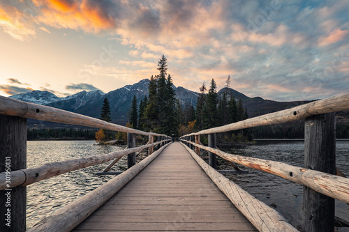 Wooden bridge in Pyramid lake with colorful sky at evening