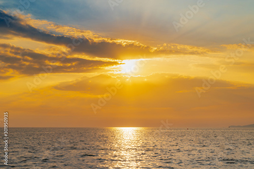 landscape of sunset on the coast sea  waves  horizon. top view.