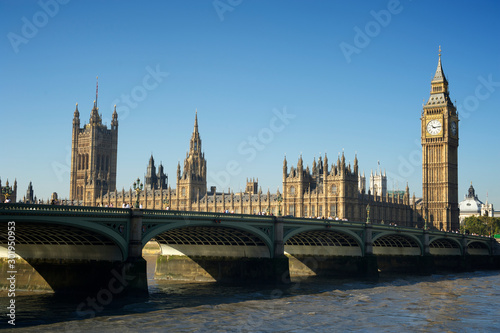 Scenic view of the Houses of Parliament and Westminster Bridge from the south bank of the River Thames on a calm morning in London, UK 