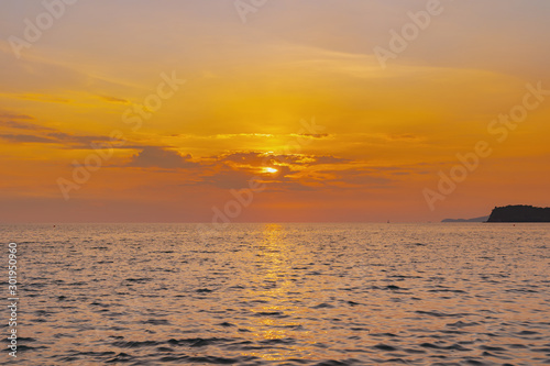 landscape of sunset on the coast sea  waves  horizon. top view.