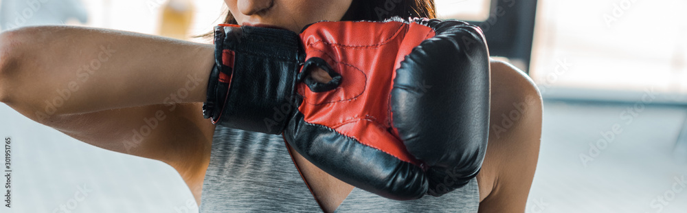 panoramic shot of sportswoman in boxing glove in sports center - obrazy, fototapety, plakaty 
