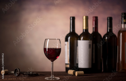Red Wine in glass and bottles on a dark background with copy space