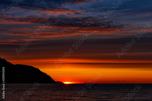 Colorful sunrise at Baikal lake with blue and red clouds © bander