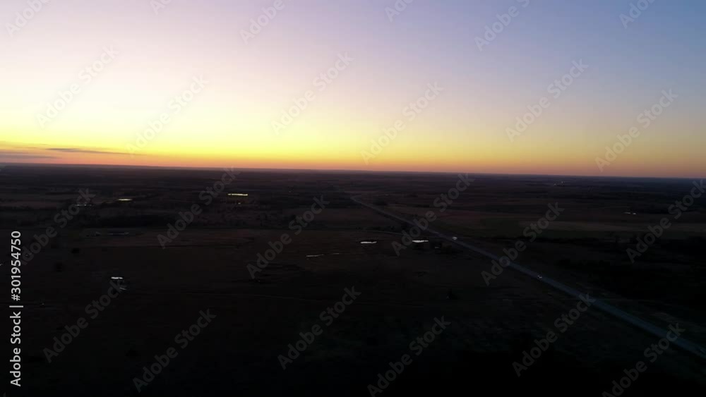 Aerial view of a highway and a rural field at sunset on a fall day. beautiful sunset, cloudless sky. Kansas sunset, dusk. Truck on Highway Aerial view of a highway and a rural field at sunset on a fall day. beautiful sunset, cloudless sky. Kansas sunset, dusk. Truck on Highway