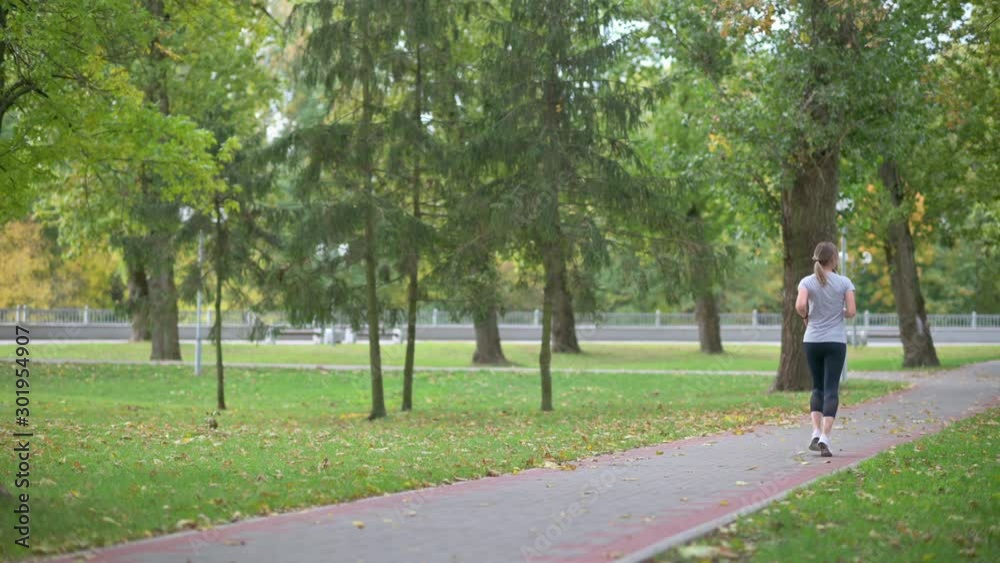 Girl athlete jogging in the park. Fitness. Healthy lifestyle. Girl athlete jogging in the park. Fitness. Healthy lifestyle.
