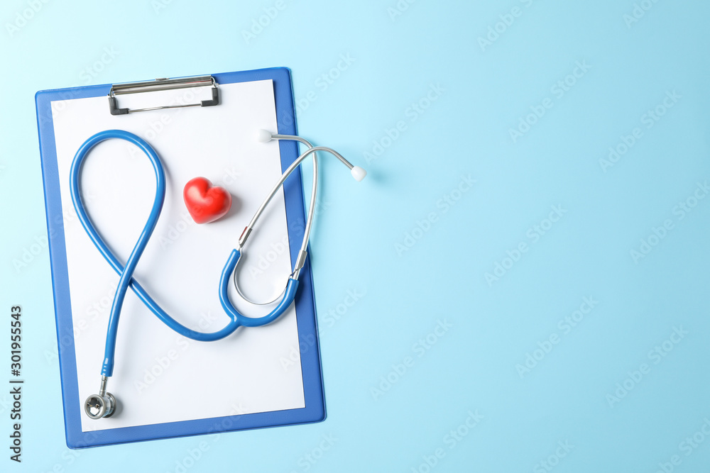 Stethoscope and heart on blue background, space for text Stethoscope and heart on blue background, space for text