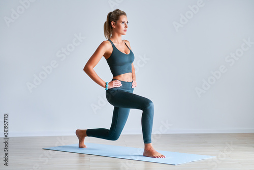 Fototapeta Naklejka Na Ścianę i Meble -  Adult woman practising yoga at home