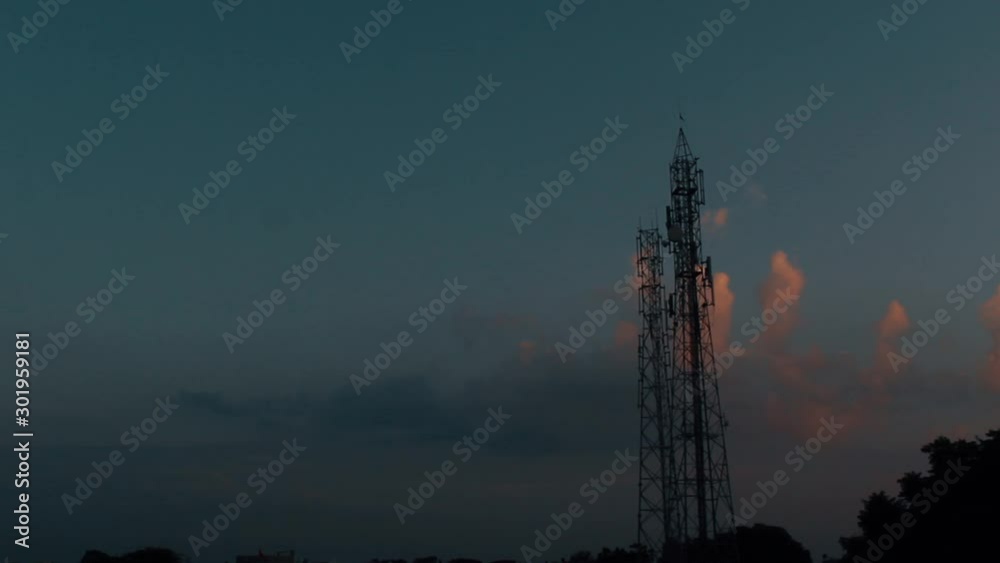 Timelapse of clouds behind the mobile tower during the sunset Timelapse of clouds behind the mobile tower during the sunset