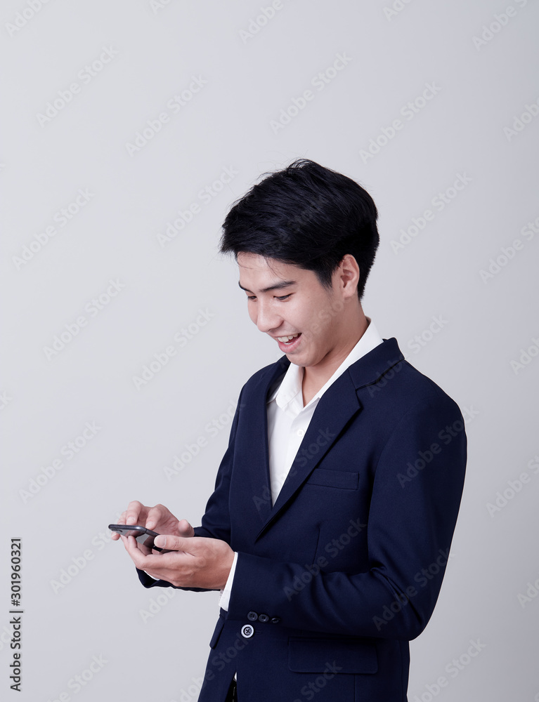 Young asian businessman using a smart phone Young asian businessman using a smart phone