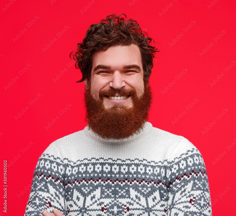 Fototapeta premium Positive bearded guy in sweater