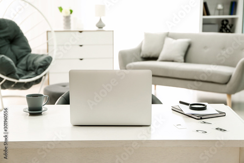 Comfortable workplace with modern laptop in room