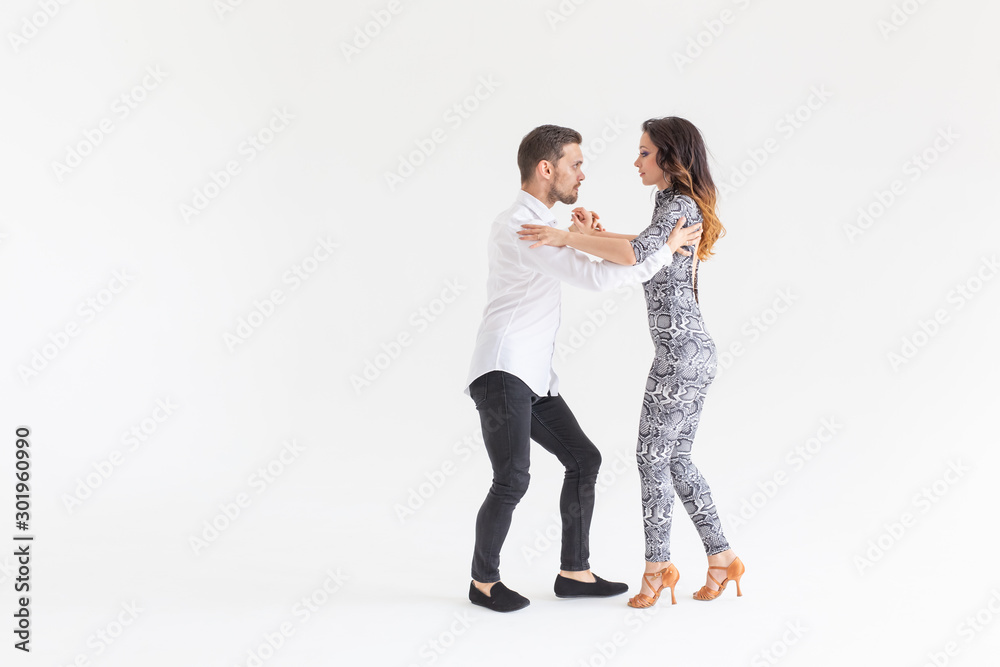 Passionate couple dancing social danse kizomba or bachata or semba or taraxia on white background with copy space Passionate couple dancing social danse kizomba or bachata or semba or taraxia on white background with copy space