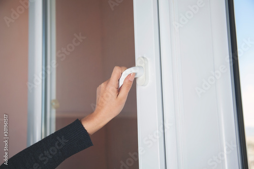 woman opening window door