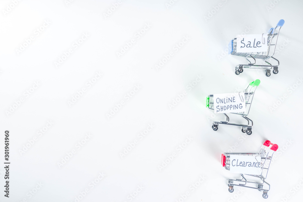 Online shopping and sale concept flat lat. Shopping trolley cart with paper note list, with text sale, clearance, online shopping. Flat lay on white background