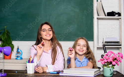 Play and learn on September 1. Happy small child and teacher hold markers on September 1. Little pupil have drawing lesson on September 1. Back to school on September 1