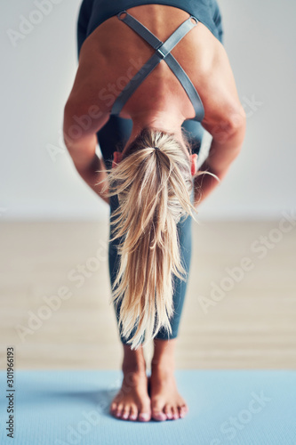 Adult woman practising yoga at home photo