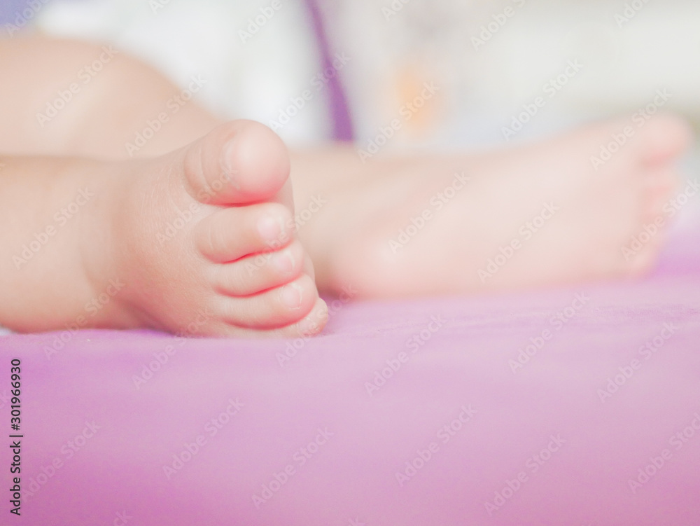 Children's feet. Looks from a knitted pastel blanket. Close-up. A place to write. Placing text. defocus Children's feet. Looks from a knitted pastel blanket. Close-up. A place to write. Placing text. defocus