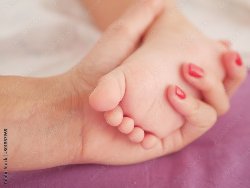 Children's feet. Looks from a knitted pastel blanket. Close-up. A place to write. Placing text. defocus Children's feet. Looks from a knitted pastel blanket. Close-up. A place to write. Placing text. defocus