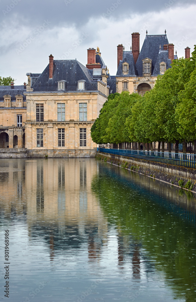 Park, pond and the palace of Fontainebleau in France.