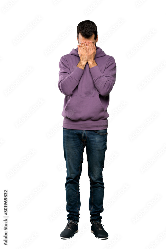 Full-length shot of Handsome man with sweatshirt with tired and sick expression over isolated white background Full-length shot of Handsome man with sweatshirt with tired and sick expression over isolated white background