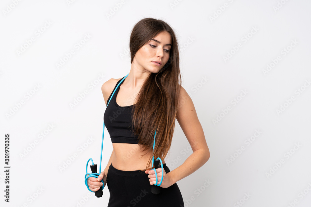 Young sport woman over isolated white background with jumping rope Young sport woman over isolated white background with jumping rope
